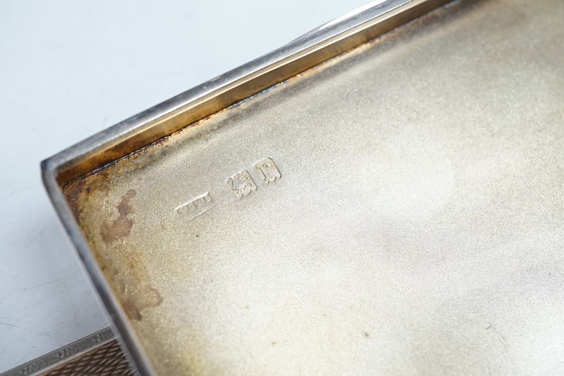 A small George V silver box and cover, possibly for snuff, by Mappin & Webb, London, 1912, 95mm, together with a later engine turned silver cigarette case, 10.6oz.